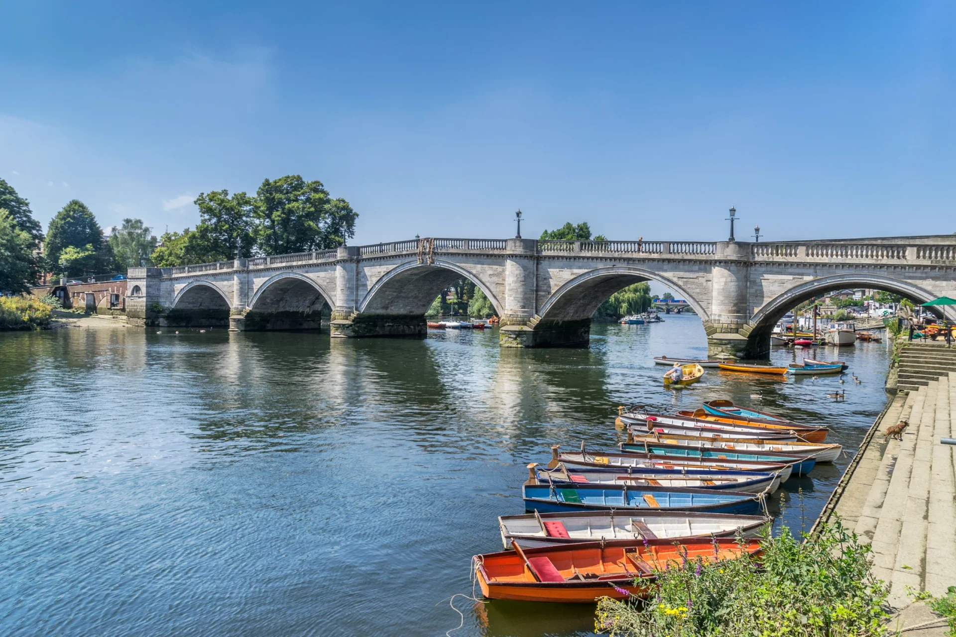 Bridge over water with boats in the foreground